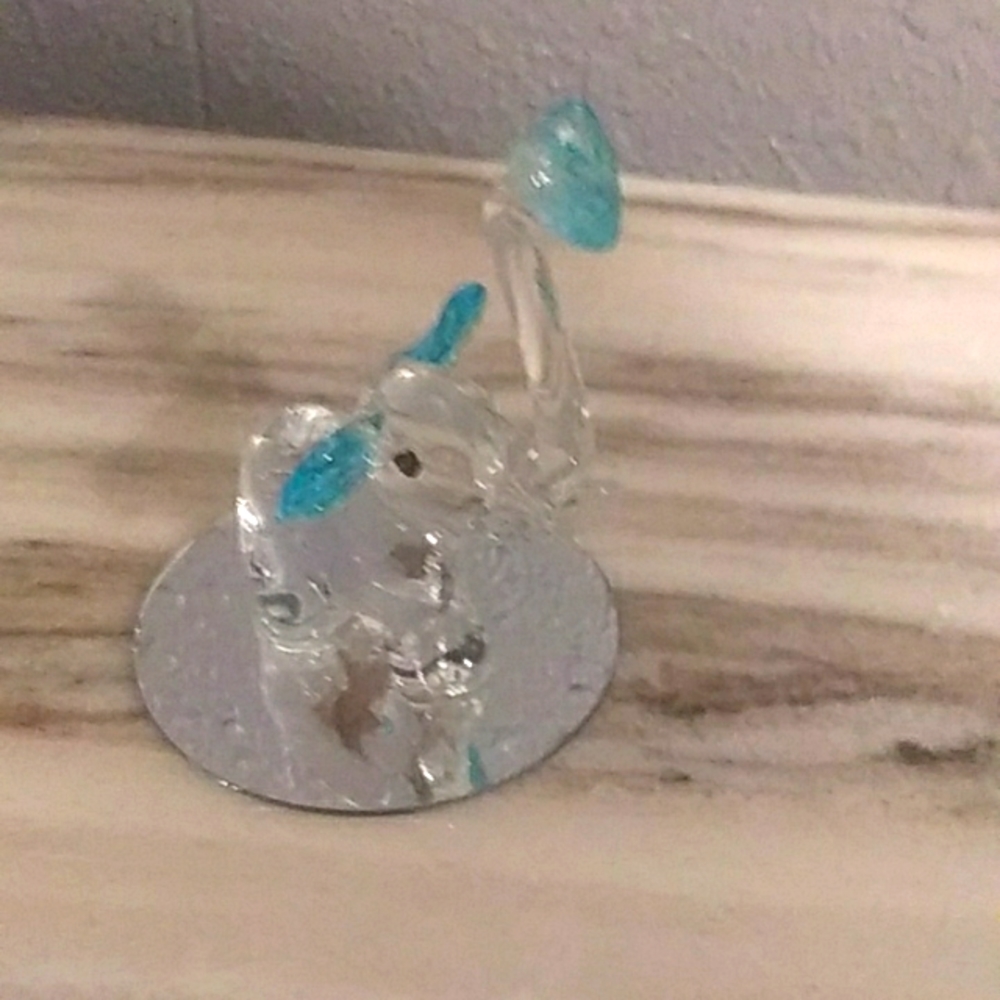 Small Momentum Blown Glass Elephant Holding Blue Heart Mounted On An Mirror